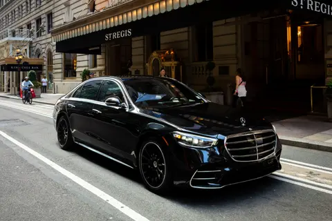 DV Executive black Mercedes-Benz S-Class sedan at a Midtown Manhattan hotel entrance